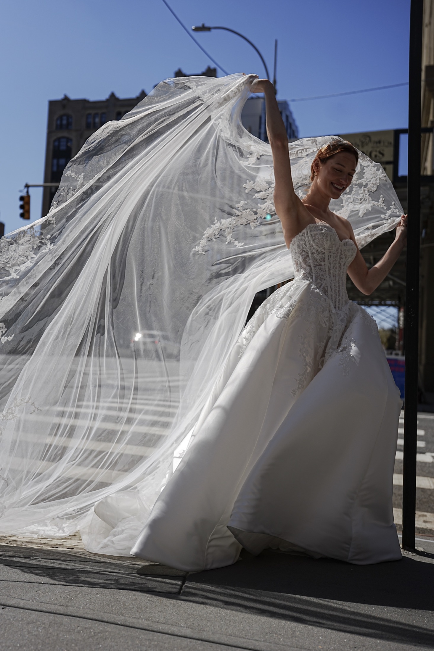 Bride with a flowing veil in the city